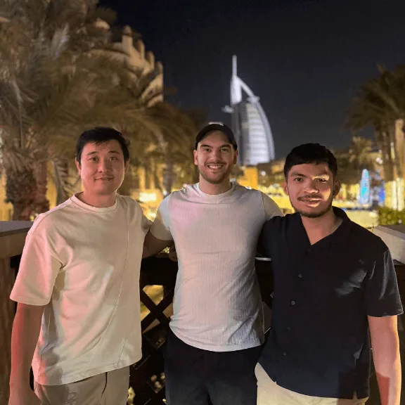 Three Convoy team members in Dubai with the Burj Al Arab behind them
