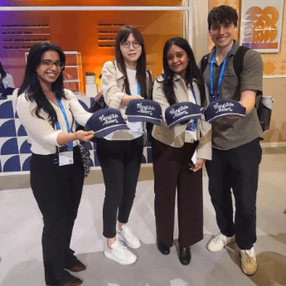 Convoy Finance team holding conference pennants at an event